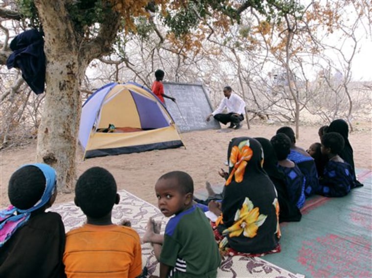 Children study under a tree in a makeshift settlement outside the village of Dertu in northeastern Kenya. Dertu looks no different from thousands of villages that dot the impoverished landscape of sub-Saharan Africa, except for the cell phone tower that keeps it in touch with the outside world. This is one of 14 "Millennium Villages" envisioned as launch pads for a mass leap out of poverty, one of the targets which the U.N. set itself a decade ago, and which will be reviewed at a summit opening Monday.